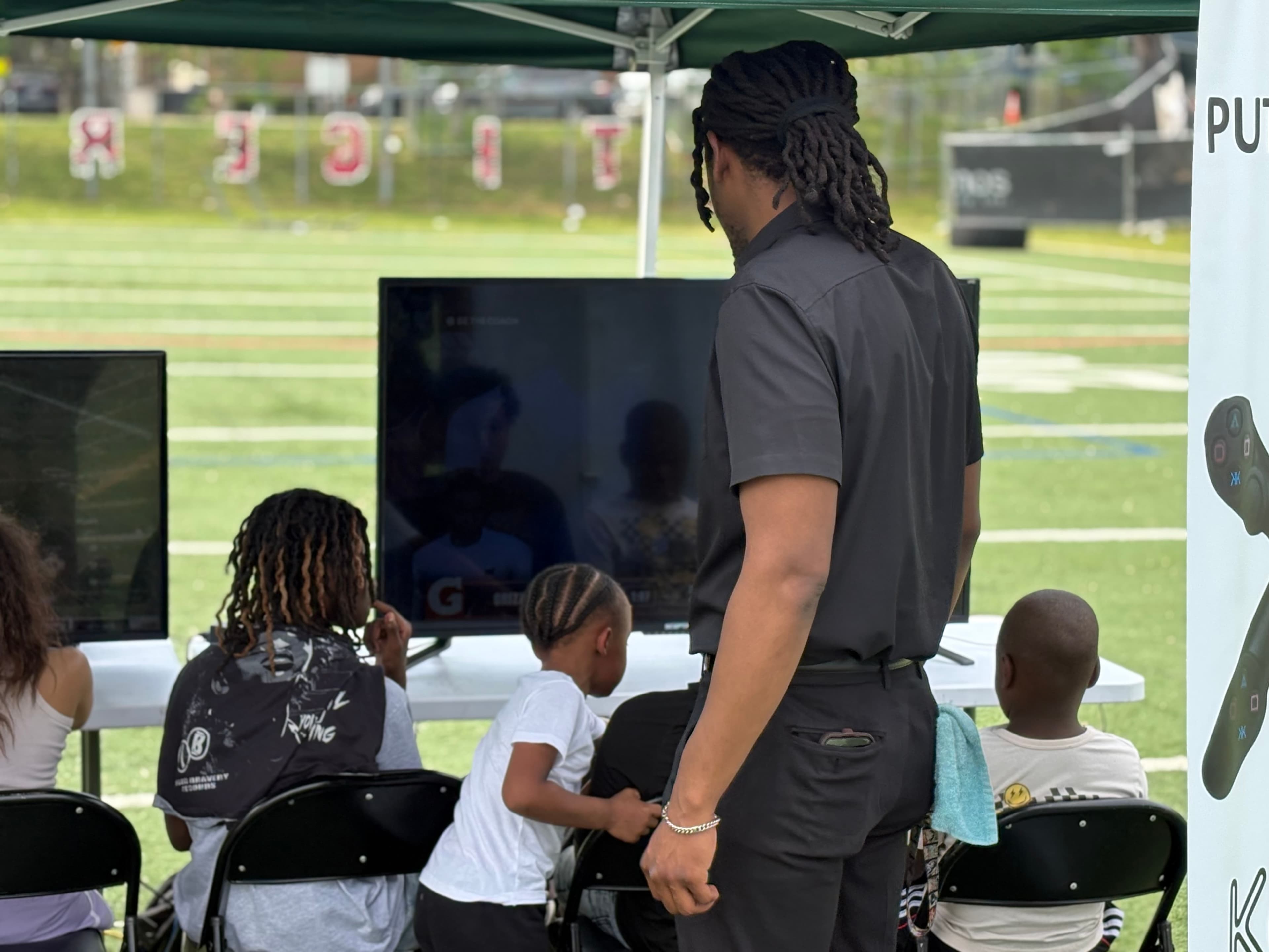 Facilitator overseeing youth gaming session at outdoor event