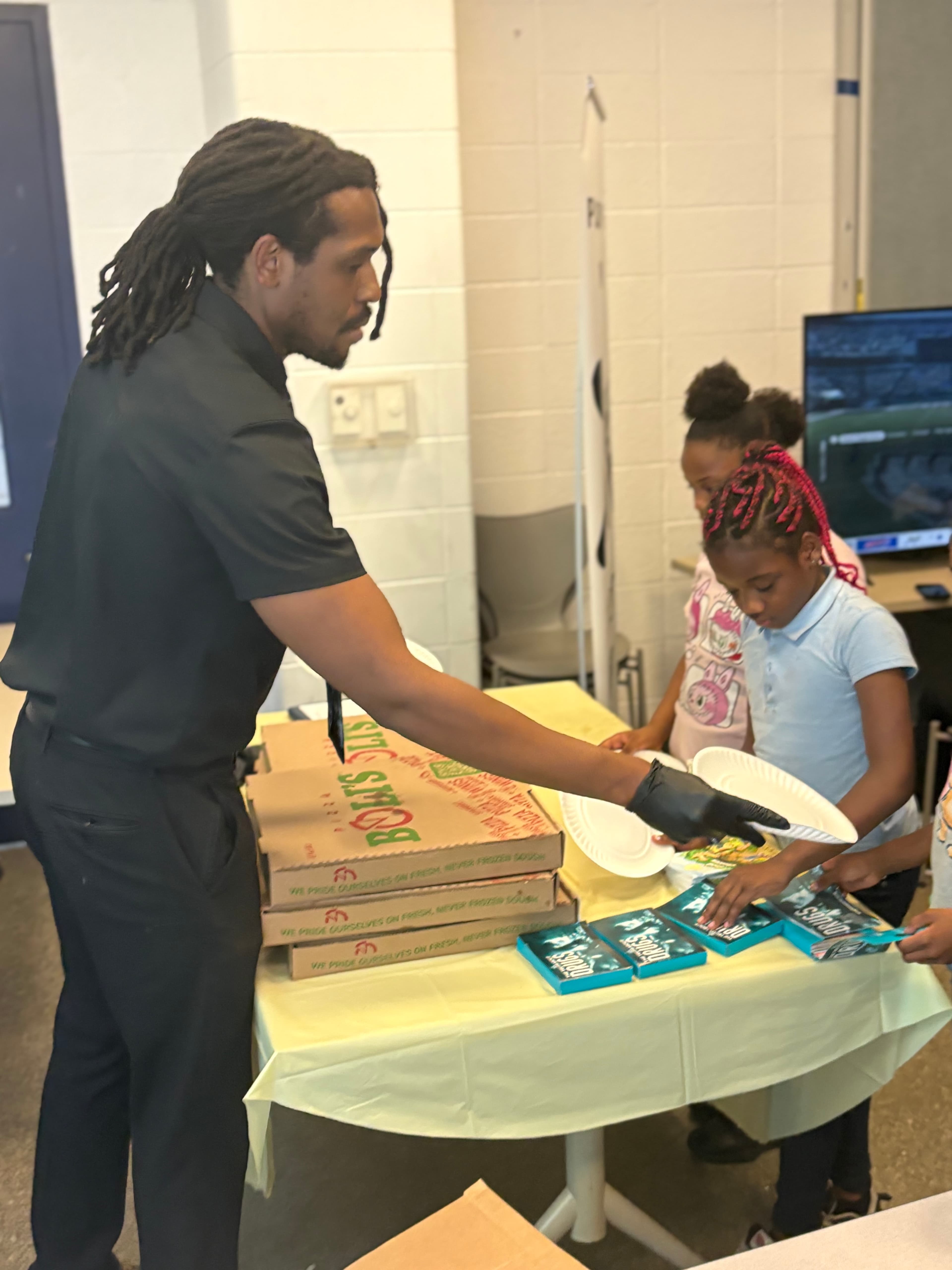 Facilitator distributing supplies to youth participants