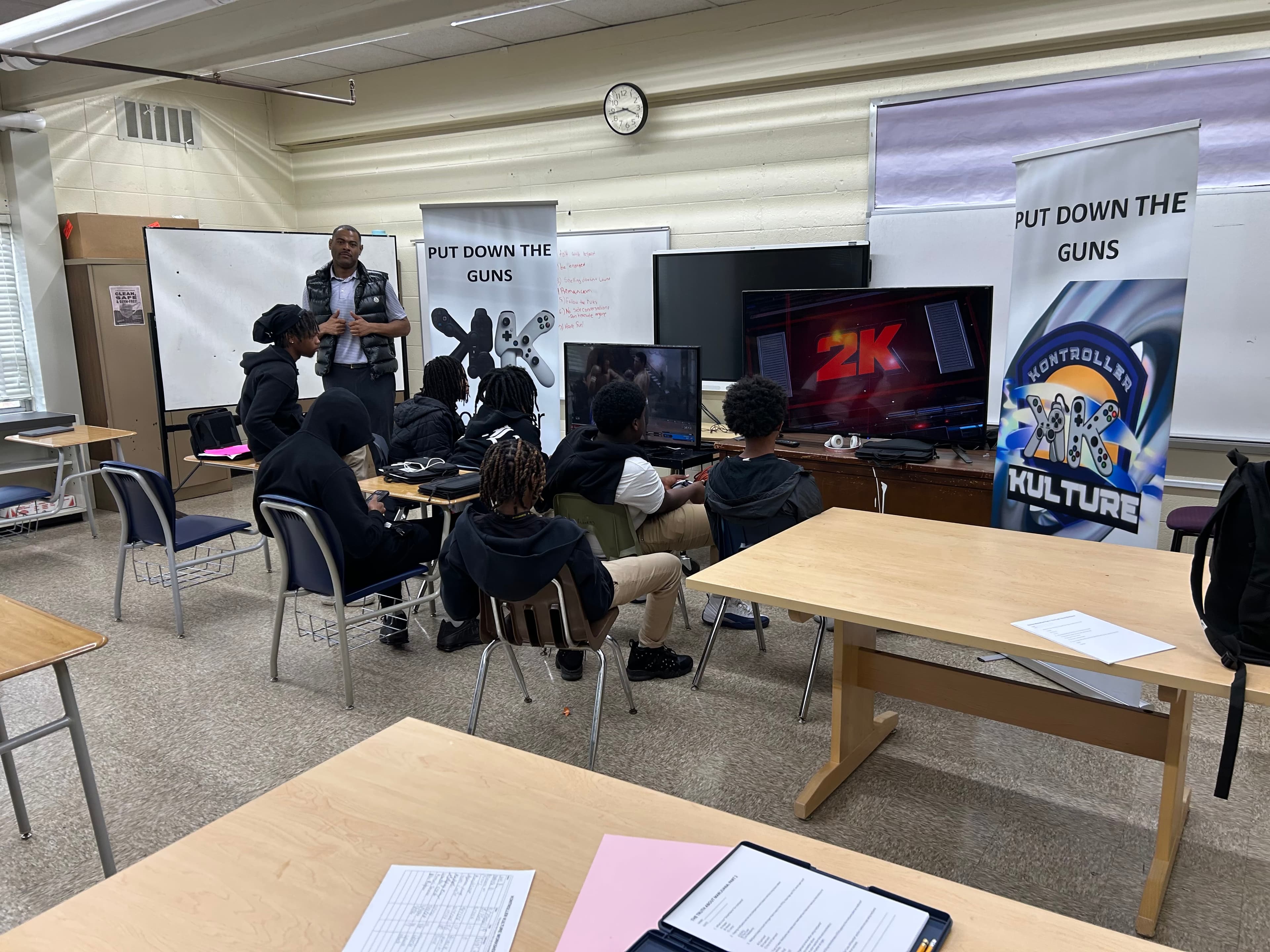 Youth engaged in gaming session at school with instructor